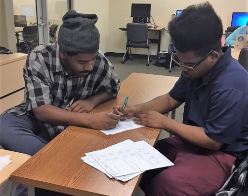 Student getting help for his math exam in the ASTC main campus location.