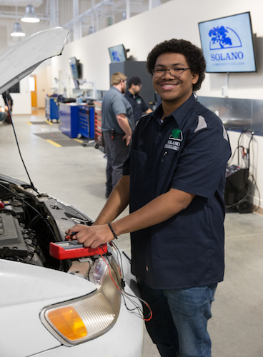 Student working a car engine