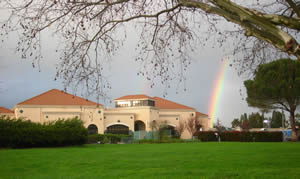 Photo of the Childrens with Rainbow in Background' Center Building