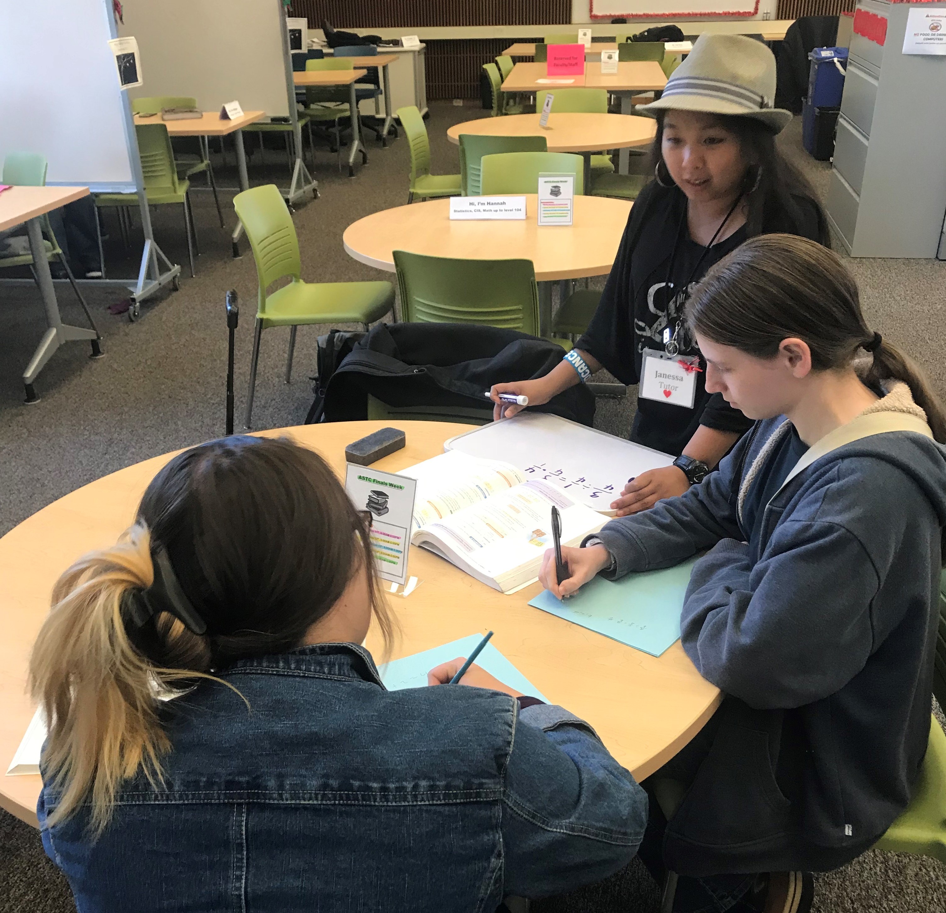 Students getting help from a wonderful student tutor.