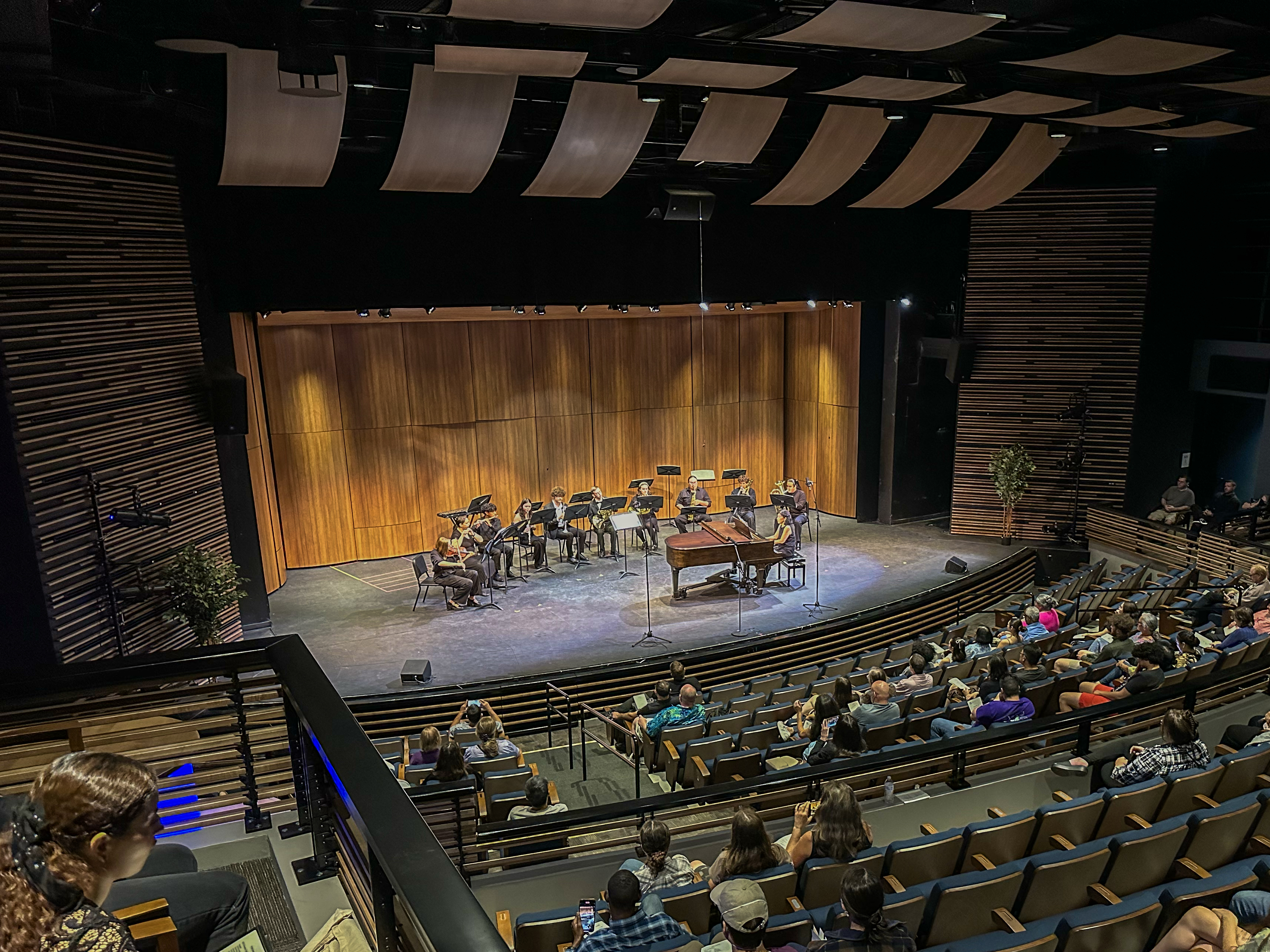 View of stage with muscians from back of concert hall