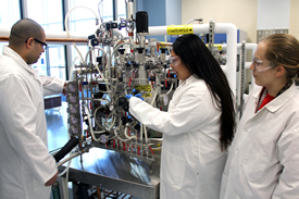 Image of Students and Instructor Working with Bioreactor