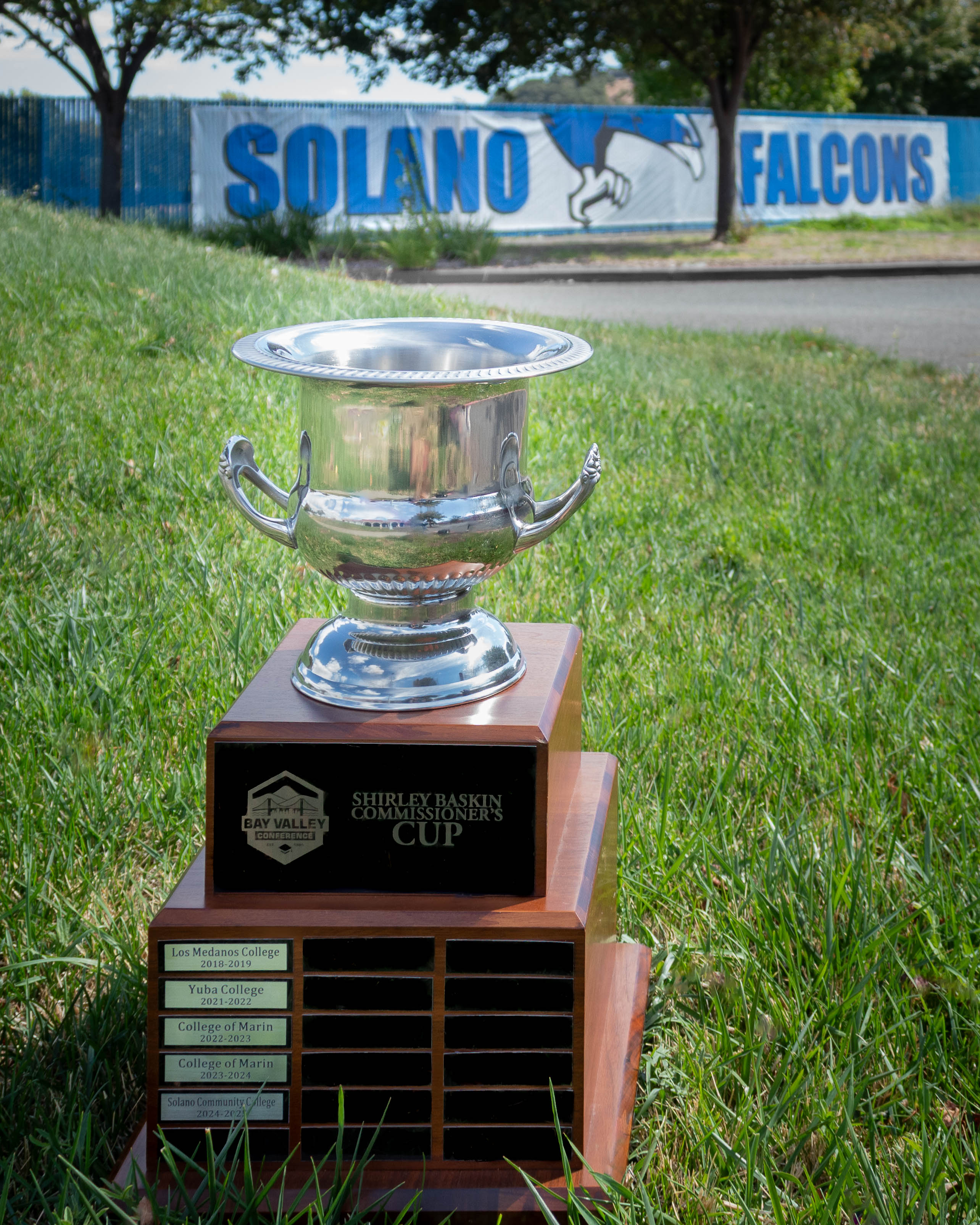 Bay Valley Commissioner's Cup sits in grass with Solano Falcon logo in background
